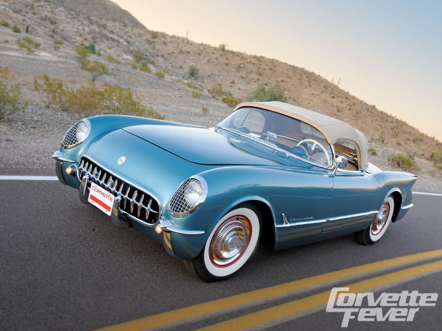 Blue car driving road hillside free wallpaper for desktop - medium preview image