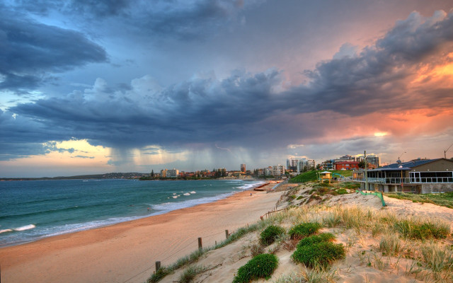Beach cloudy sky buildings grass free wallpaper for desktop - medium preview image