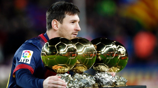 Man holding three soccer balls free wallpaper for desktop - medium preview image