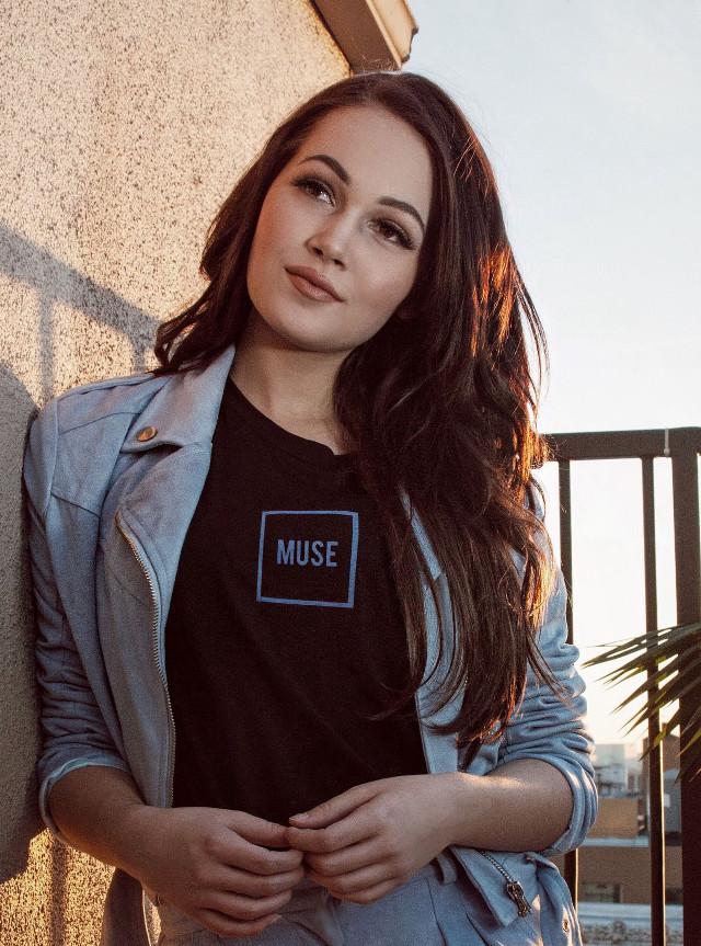 Woman standing wall black shirt free wallpaper for mobile - medium preview image