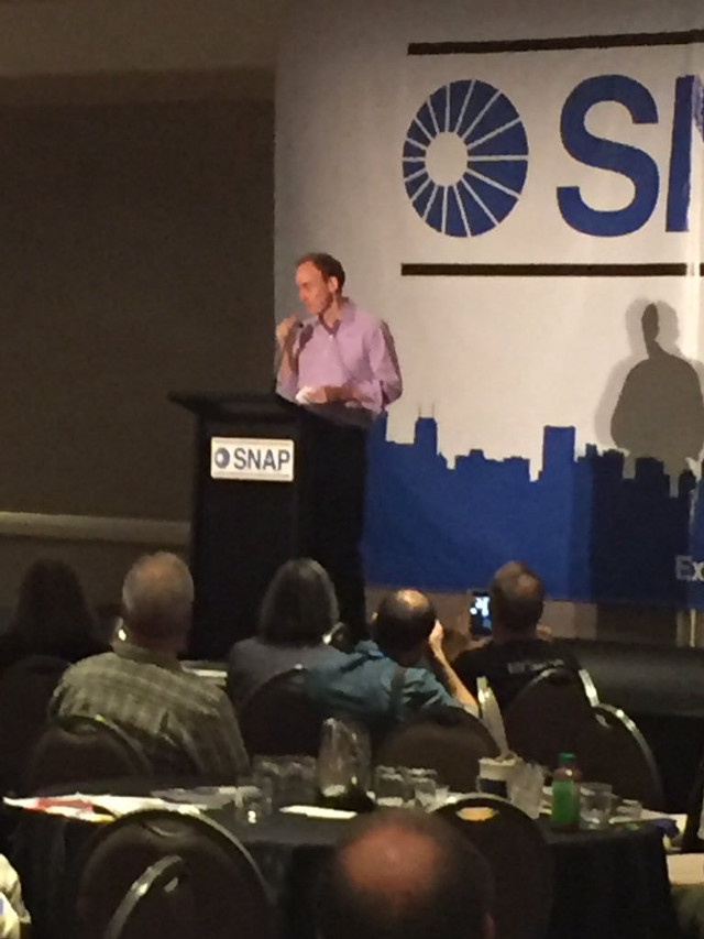 Man standing podium crowd conference free wallpaper for mobile - medium preview image