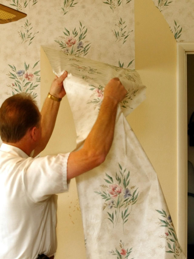 Man putting up wallpaper flowered free wallpaper for mobile - medium preview image