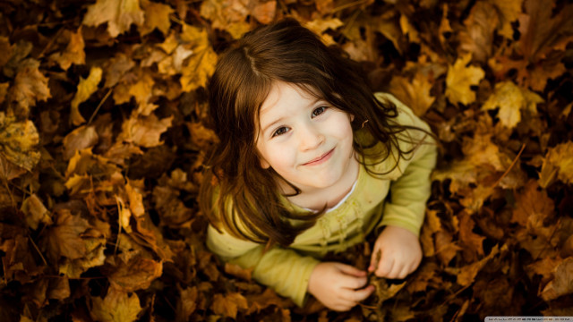 Smiling girl lying autumn leaves free wallpaper for desktop - medium preview image