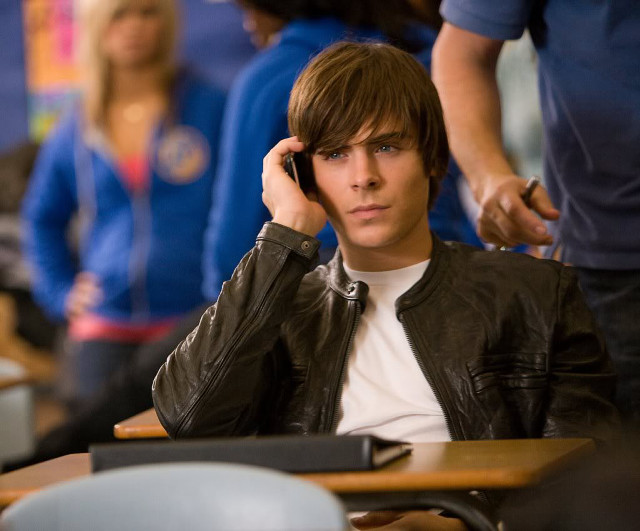 Young man desk talking cell free wallpaper for desktop - medium preview image