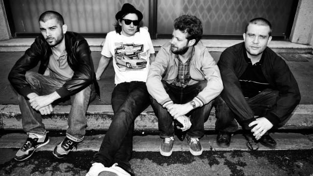 Men bench sidewalk building group free wallpaper for desktop - medium preview image