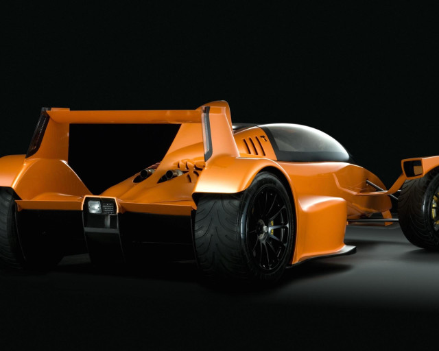 Orange race car dark room free wallpaper for desktop - medium preview image