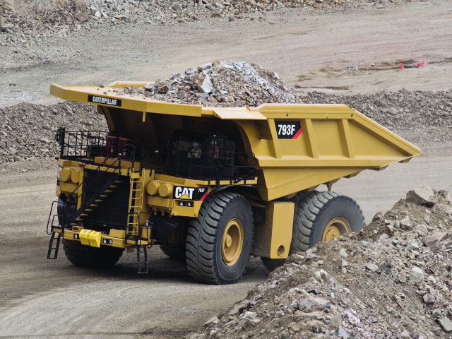 Dump truck dumping rocks desert free wallpaper for desktop - medium preview image
