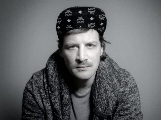 Man hat sitting serious looking free wallpaper for desktop - medium preview image