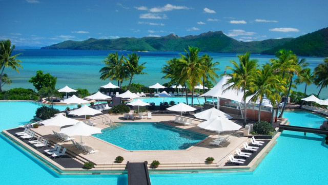 Resort pool umbrellas chairs ocean free wallpaper for desktop - medium preview image