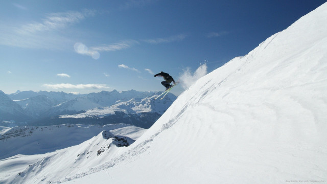 Snowboarder jumping snowy hill mountains free wallpaper for desktop - medium preview image