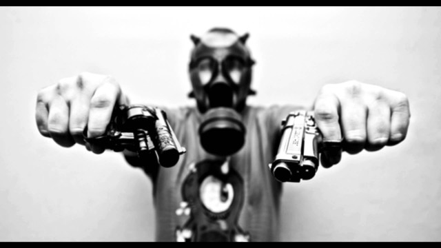 Man gas mask holding guns free wallpaper for desktop - medium preview image