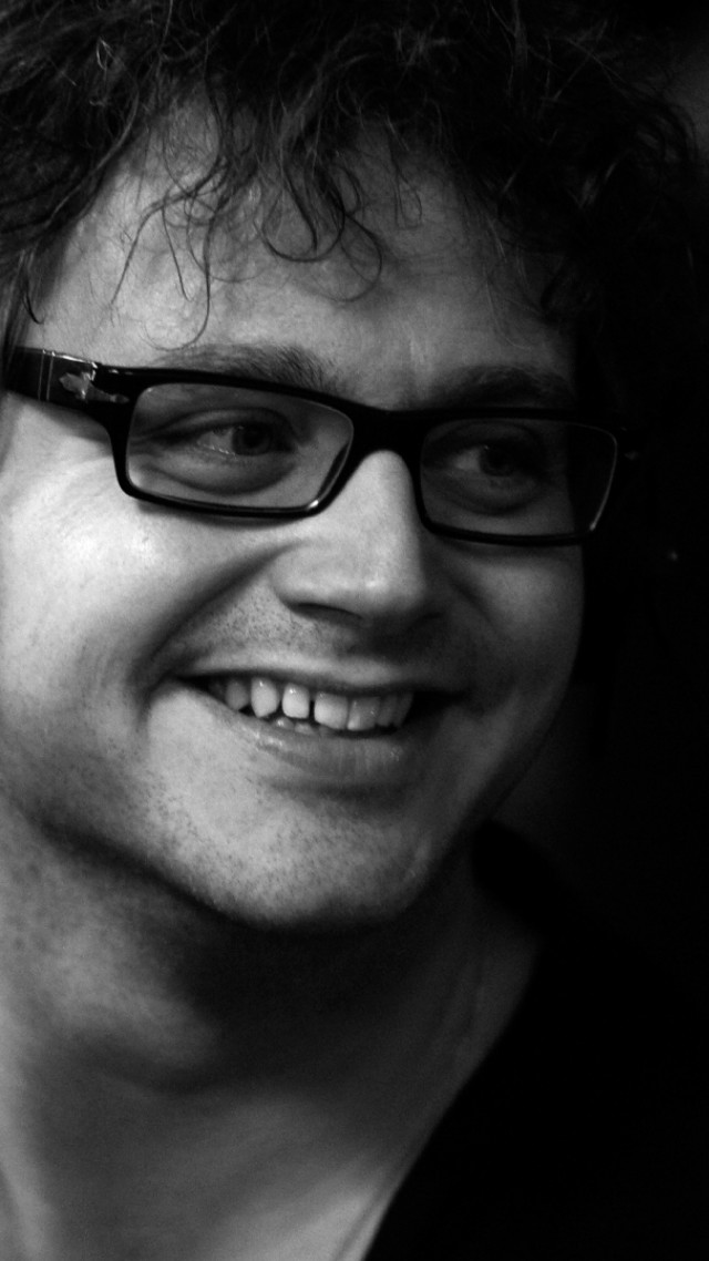 Man glasses smiling cellphone photorealism free wallpaper for mobile - medium preview image