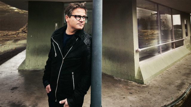 Man leaning pole building window free wallpaper for desktop - medium preview image