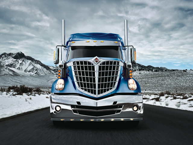 Blue semi truck driving road free wallpaper for desktop - medium preview image