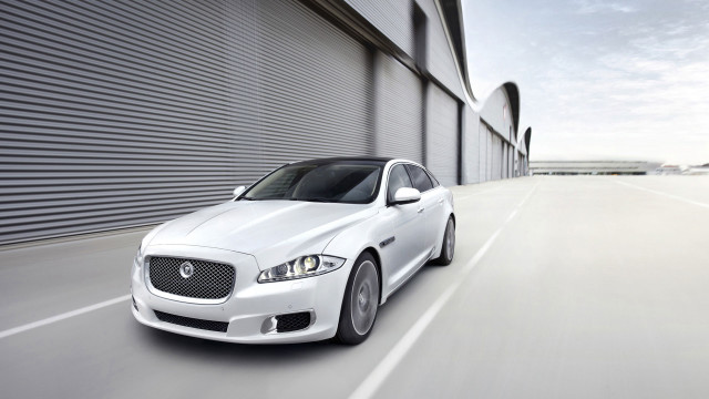 White car driving street building #3 free wallpaper for desktop - medium preview image