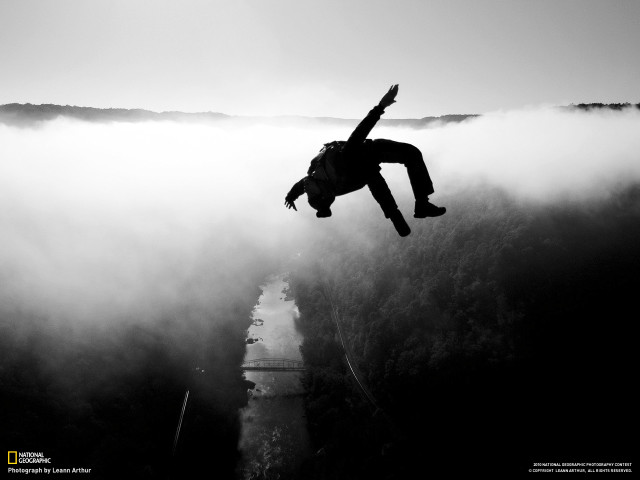 Man jumping off cliff arms free wallpaper for desktop - medium preview image