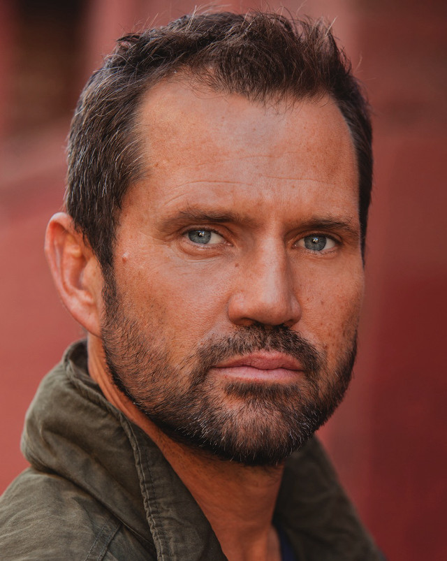 Man beard green jacket serious free wallpaper for mobile - medium preview image