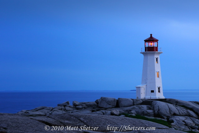Lighthouse rocky shore ocean night free wallpaper for desktop - medium preview image