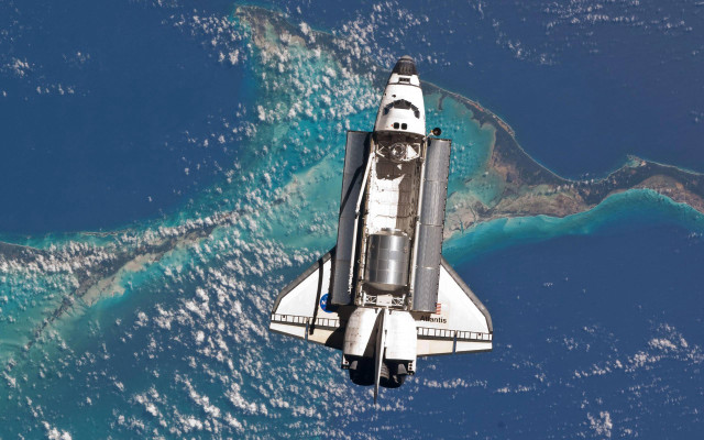 Space shuttle flying ocean landforms free wallpaper for desktop - medium preview image