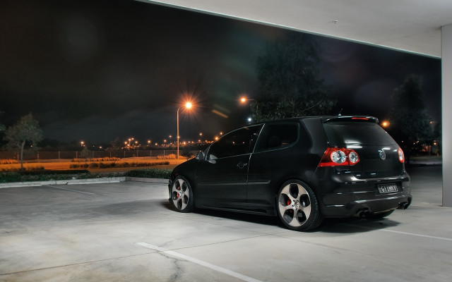 Black car parked night lights free wallpaper for desktop - medium preview image