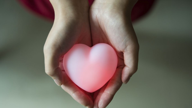 Person holding heart pink glow free wallpaper for desktop - medium preview image