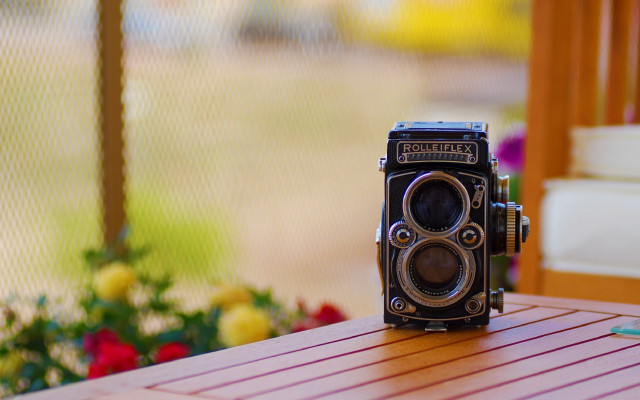 Camera table flowers fence tiltshift free wallpaper for desktop - medium preview image