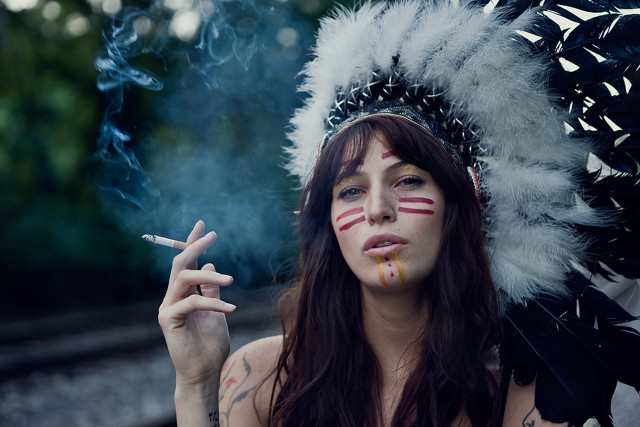 Woman feather headdress smoking cigarette free wallpaper for desktop - medium preview image