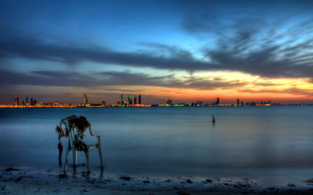 Man beach ocean sunset city free wallpaper for desktop - medium preview image