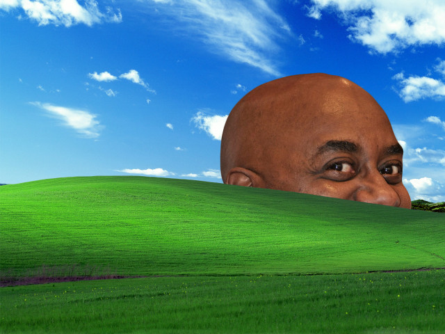 Man peeking green hill blue free wallpaper for desktop - medium preview image