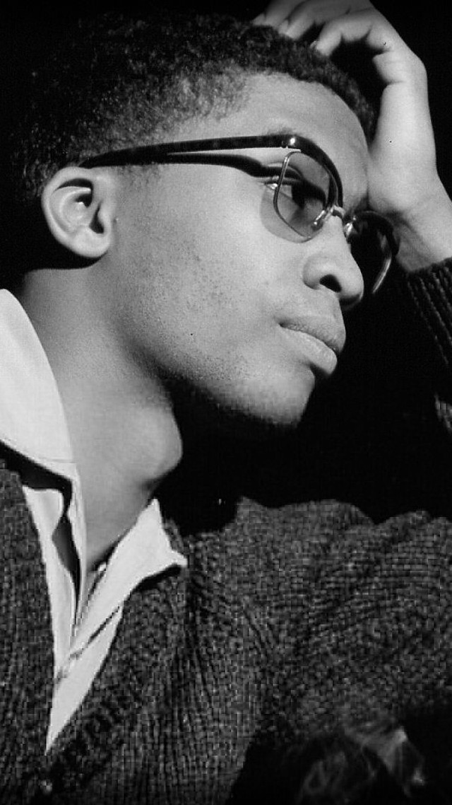 Man glasses sweater leaning wall free wallpaper for mobile - medium preview image