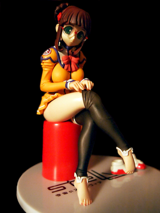Figurine girl stool sitting crossed free wallpaper for mobile - medium preview image