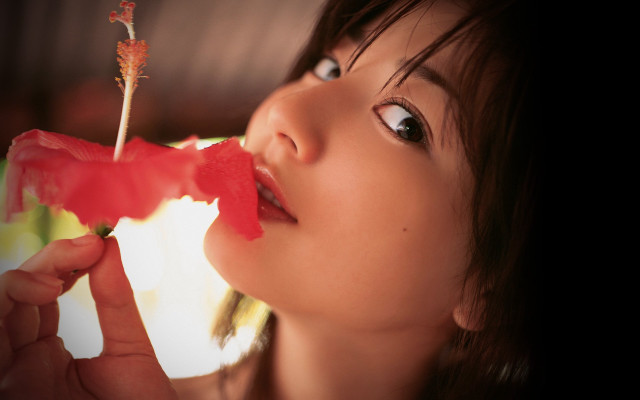 Woman holding flower mouth looking free wallpaper for desktop - medium preview image