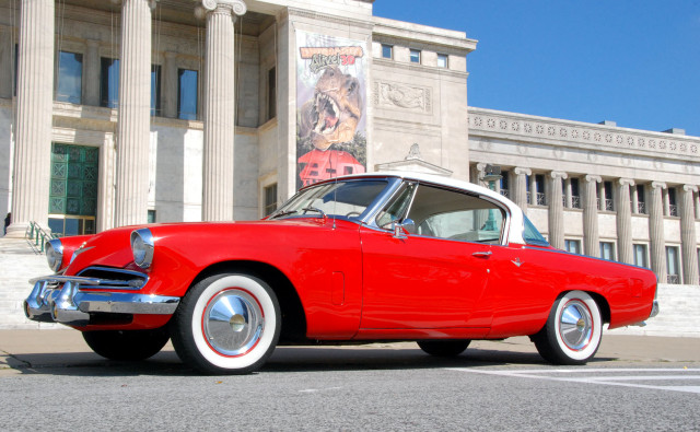 Red car parked building columns free wallpaper for desktop - medium preview image