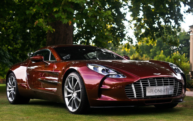 Red sports car grassy area free wallpaper for desktop - medium preview image