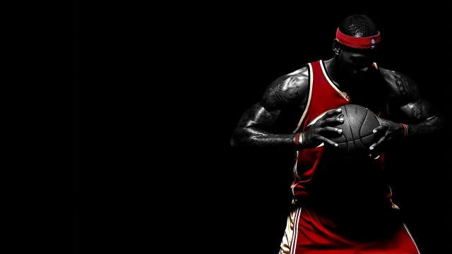 Man holding basketball red uniform #2 free wallpaper for desktop - medium preview image