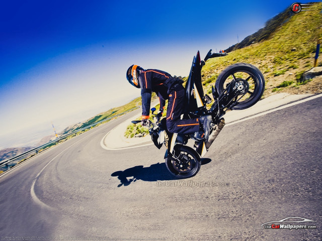 Man motorcycle trick road hill free wallpaper for desktop - medium preview image