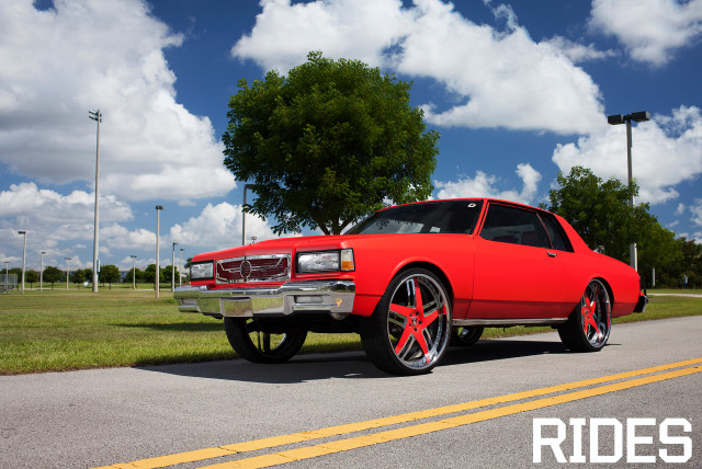 Red car parked road grass #2 free wallpaper for desktop - medium preview image