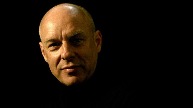 Bald man black shirt serious free wallpaper for desktop - medium preview image