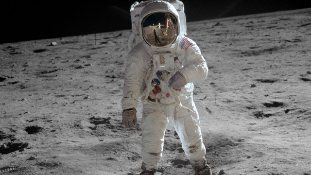 Astronaut standing on moon foot free wallpaper for desktop - medium preview image