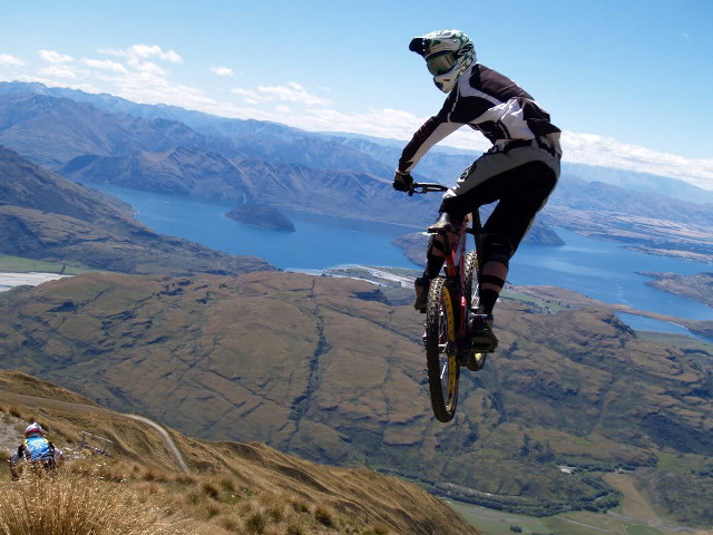 Man riding bike mountain lake free wallpaper for desktop - medium preview image