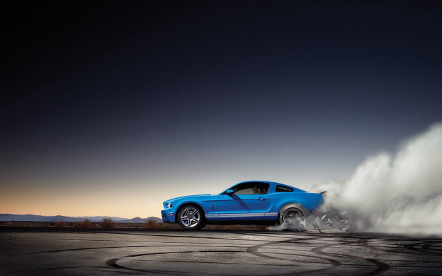 Blue mustang driving dusty road free wallpaper for desktop - medium preview image