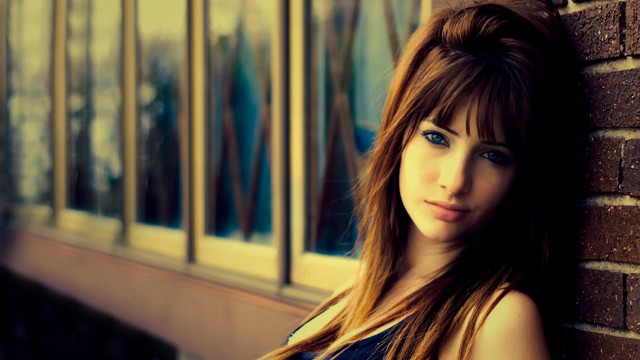 Woman brick wall serious look free wallpaper for desktop - medium preview image