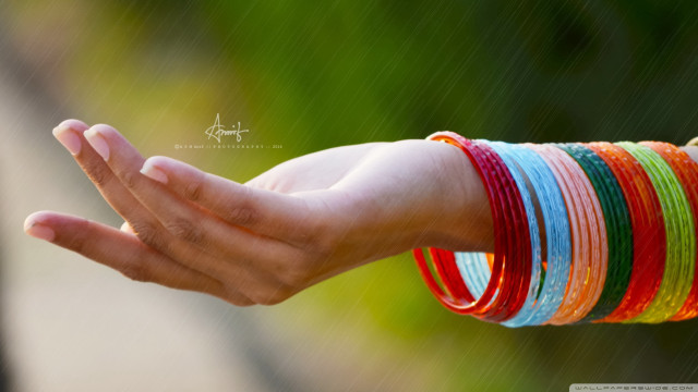 Person holding bracelets blurry background free wallpaper for desktop - medium preview image