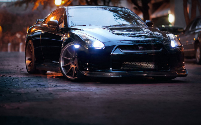 Black car parked night person free wallpaper for desktop - medium preview image