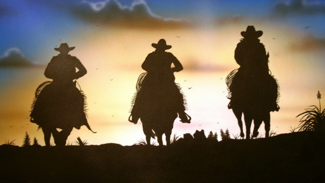 Cowboys silhouettes horseback sunset sky free wallpaper for desktop - medium preview image