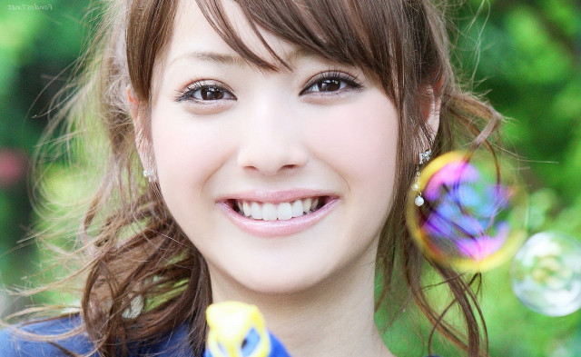 Young woman smiling holding soapy free wallpaper for desktop - medium preview image