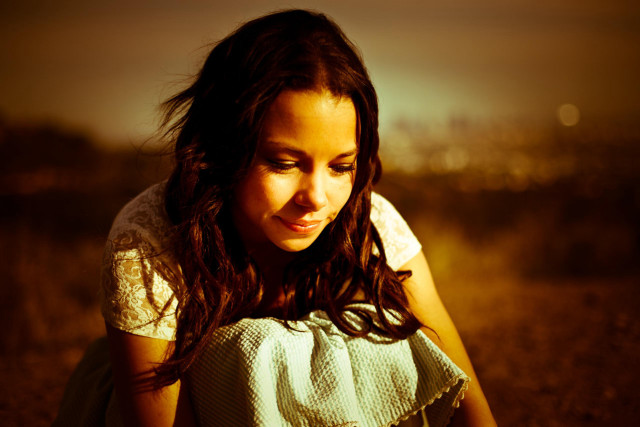 Girl sitting field cellphone city free wallpaper for desktop - medium preview image