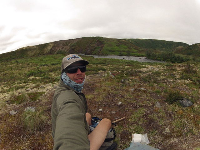 Man sitting rock field mountain free wallpaper for desktop - medium preview image