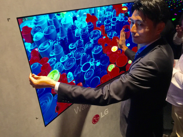 Man suit holding screens interactive free wallpaper for desktop - medium preview image