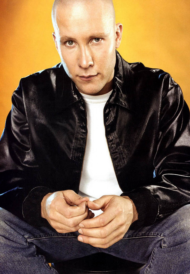 Bald man black jacket jeans free wallpaper for mobile - medium preview image